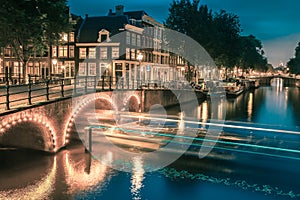 Night city view of Amsterdam canal and bridge