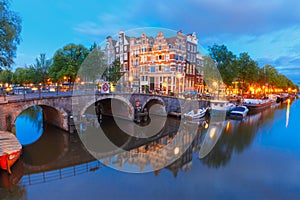 Night city view of Amsterdam canal and bridge