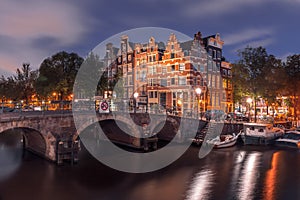 Night city view of Amsterdam canal and bridge