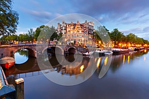 Night city view of Amsterdam canal and bridge