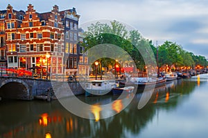 Night city view of Amsterdam canal and bridge