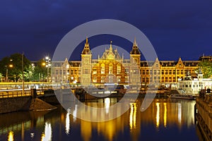 Night city view of Amsterdam canal and Centraal Station