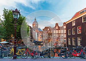 Night city view of Amsterdam canal, church and bri