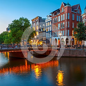 Night city view of Amsterdam canal with dutch hous