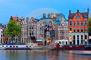 Night city view of Amsterdam canal with dutch houses