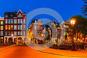 Night city view of Amsterdam canal with dutch houses