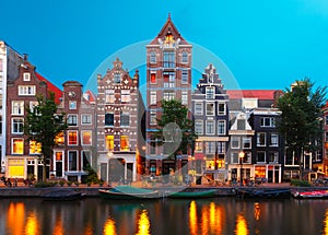 Night city view of Amsterdam canal with dutch houses