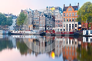 Night city view of Amsterdam canal with dutch houses