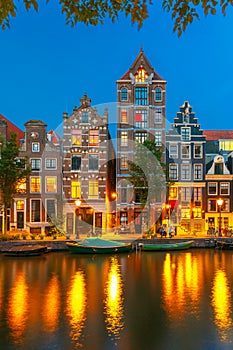 Night city view of Amsterdam canal with dutch houses