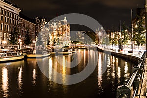 Night city view of Amsterdam channel and typical dutch houses, Holland, Netherlands.