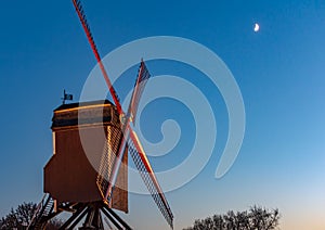 Night cityscape of Bruges city with Sint-Janshuis Mill against night blue sky