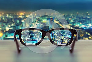 Night cityscape focused in glasses lenses photo