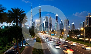 Night cityscape with highway traffic and palm trees
