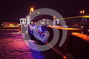 Night cityscape with river and bridge in Saint-Petersburg. Lantern lights on bridge