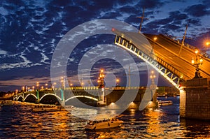 Night cityscape with river and bridge and ship in Saint-Petersburg.