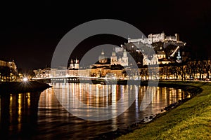 Night Cityscape Salzburg. View from the Salzach with Hohensalzburg Fortress and Cathedral, Salzburg, Austria