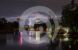 Night cityscape on the storm with lightning and business office building in Bucharest