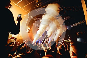 Night club silhouette crowd hands up at steam stage