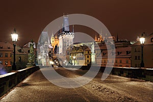Night colorful snowy Prague gothic Castle from Charles Bridge