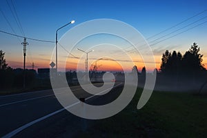 Night Country Highway Illuminated by Street Lamps at Sunset