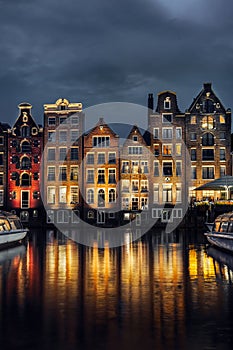 Night dancing houses at Amsterdam canal Damrak, Netherlands