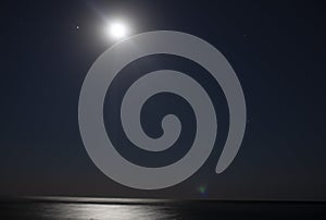 Night dark sky with moon over the sea. Long exposure of the starry sky. Romantic  background with copy space