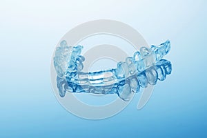Night dental guard by bruxism on blue background