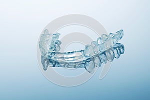 Night dental guard by bruxism, blue background photo