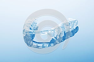 Night dental guard by bruxism on blue background photo