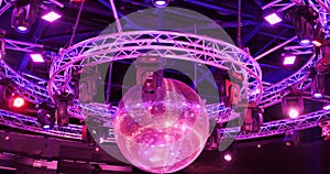 night disco club with neon blue violet red light, disco mirror ball and bright