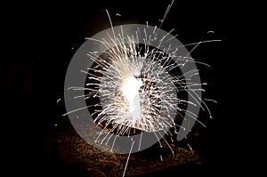 Night explosion crates full of explosive pyrotechnics. white shrub shaped white orange fireball with lots of hot shards. Cluster