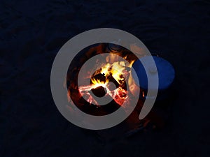 Night fire while heating food in a metal casserole on bonfire in Egypt