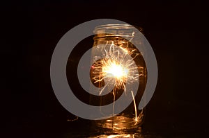 Night fireworks sparkler burning inside glass jar 1st version