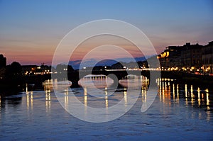 Night lights on the river in Florence city , Italy