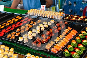 Night food market in asia. Outdoor sushi counters