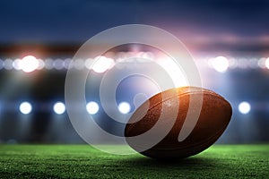 Night football arena in lights with a ball close up