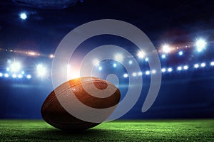 Night football arena in lights with a ball close up