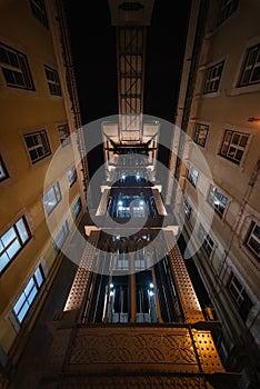 Night front view upwards of the old elevator of santa justa in lisbon