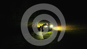 Night harvest, illuminating the fields, loading maize into trailers a vital