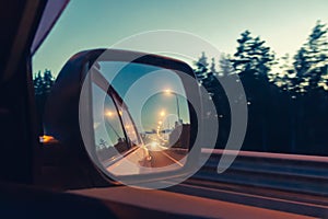 Night highway in the side mirror while driving - photo, image. Soft focus