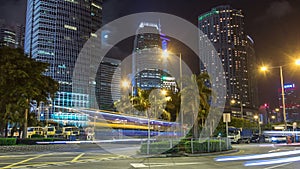 Night hyperlapse of modern city in park with fountain and skyscrapers around. Time lapse. Hong Kong