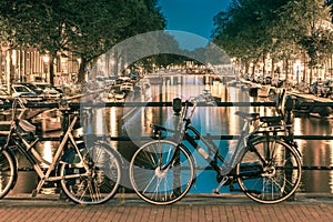 Night illumination of Amsterdam canal and bridge