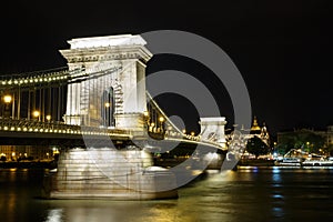 Night illumination of the chain bridge across the Danube to Budapest