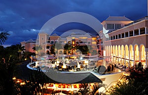 Night illumination of luxury hotel and clouds