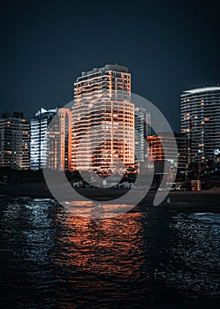 Night image of some buildings in a coastal city photo