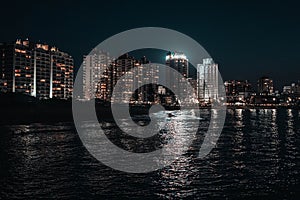 Night image of some buildings in a coastal city photo