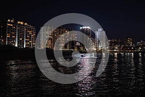 Night image of some buildings in a coastal city photo