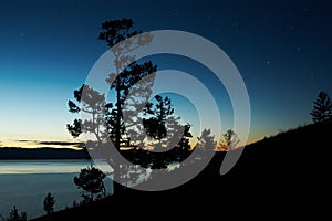 Night landscape against a decline lake Baikal