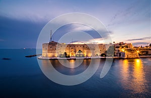 Night landscape of Aragonese Castle on seafront in Taranto. Ital