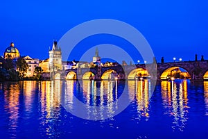 Night landscape of Charles Bridge and its reflactions in the Vltava river in Prague, Czech Republic